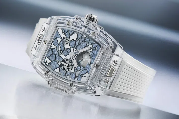 Close-up of the Hublot Spirit of Big Bang Impact in a transparent sapphire tonneau case, featuring a skeletonised dial with crystallised osmium fragments and a moonphase display