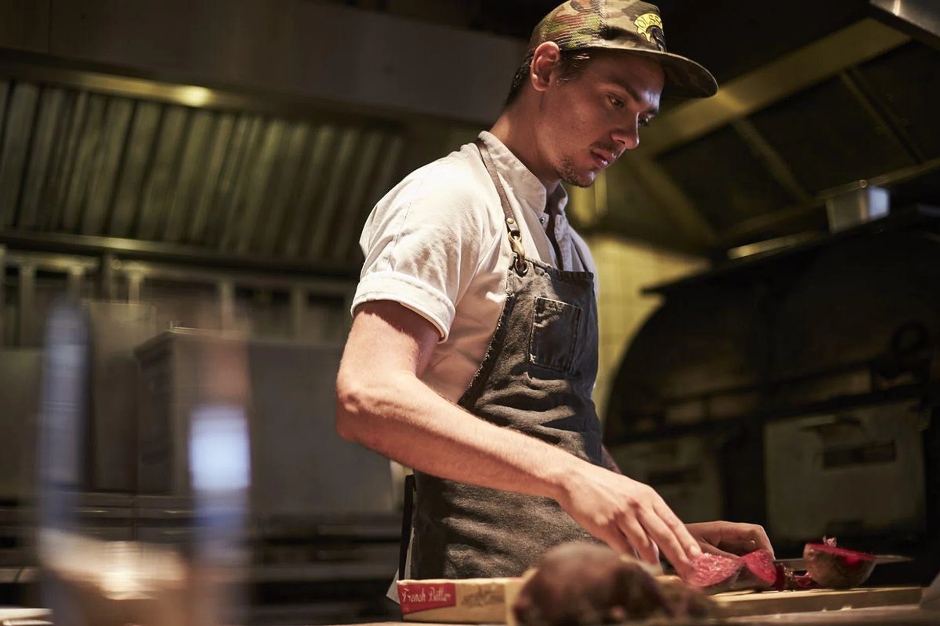 The chef preparing his pigeon dish (photo by Vee Chin)