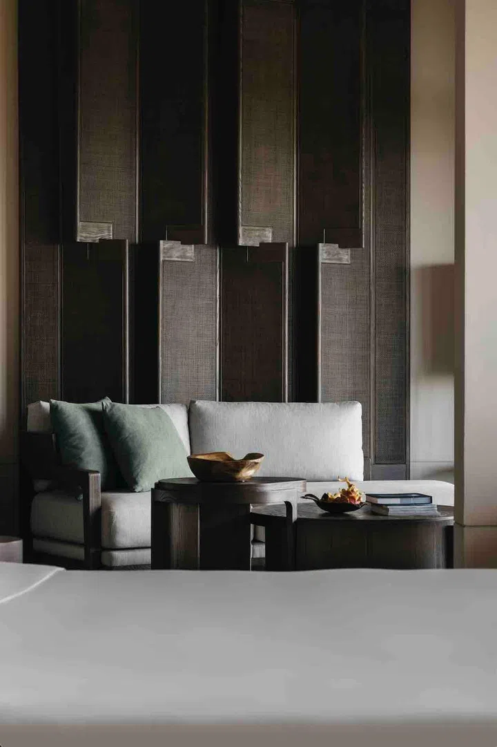 The couch in the living room of Capella Singapore's Sentosa Suite.