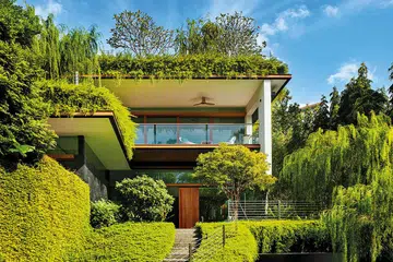 Good-Class Bungalow with sky pool by Guz Architects camouflages among greenery