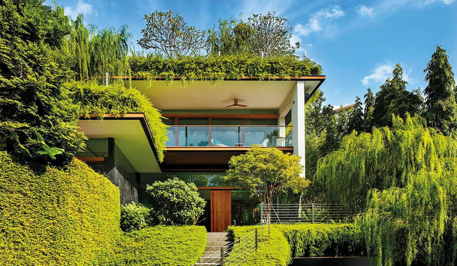 Good-Class Bungalow with sky pool by Guz Architects camouflages among greenery