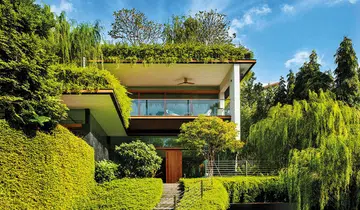 Good-Class Bungalow with sky pool by Guz Architects camouflages among greenery