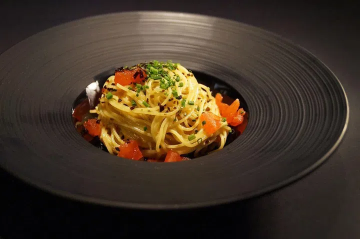 Le Binchota cappellini tossed with tomato concasse with shio kombu in a light cream broth 