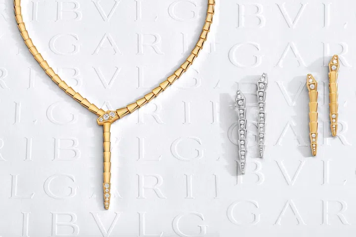 Bvlgari Serpenti Viper necklace and drop earrings in yellow and white gold, with diamond-set snake head and tail forming a sleek, coiling silhouette.