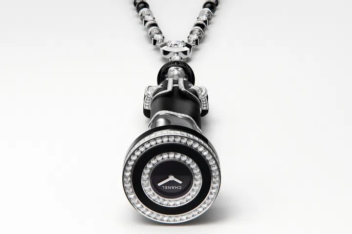Close-up of the concealed watch dial beneath Chanel’s queen chess piece, featuring a diamond-set bezel and white gold construction.