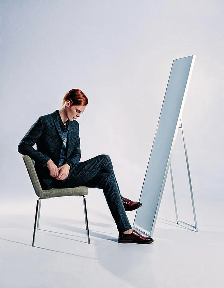 An all-over check looks best in a sleek cut. Grey wool checked suit and grey wool knit top, from Fendi. Brown leather shoes from Gucci.