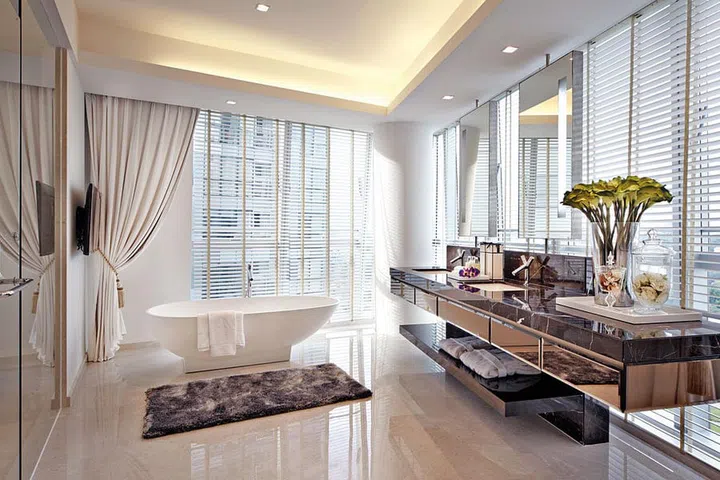 A profusion of natural light amplifies the lush finishes in the bathroom.