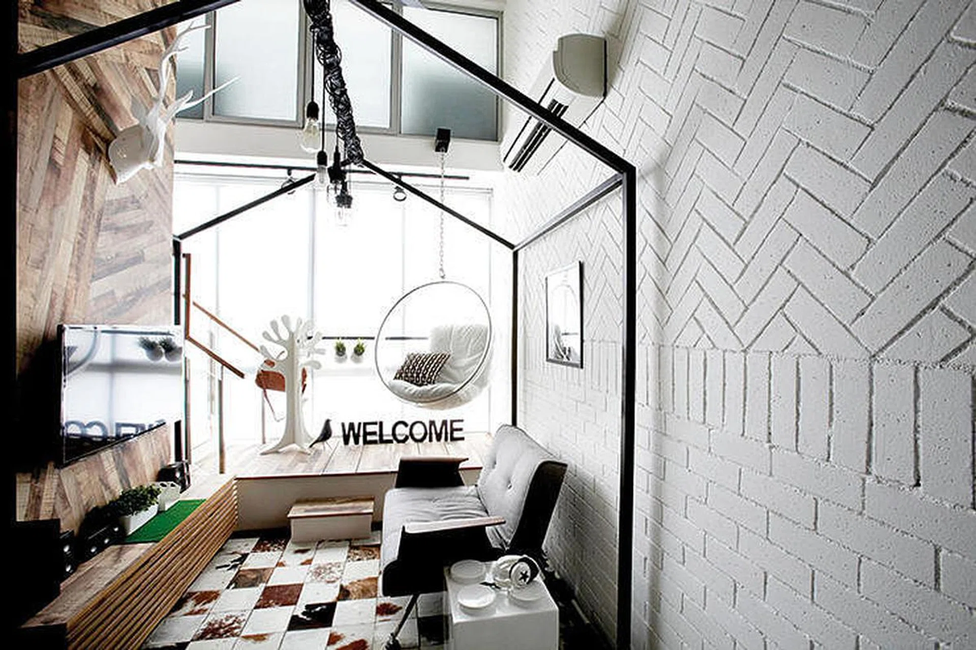 Done up in line with the loft’s modern-industrial theme, the bold architectural and decor elements of the living area are tempered by a neutral palette and whitewashed walls. Instead of an ordinary, bare brick wall, the designers had the bricks in the living room arranged in horizontal, vertical and herringbone patterns for greater visual interest.