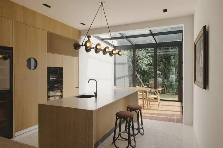A glass extension to the dry kitchen is another seating space for gatherings. (Photo: Studio Periphery)