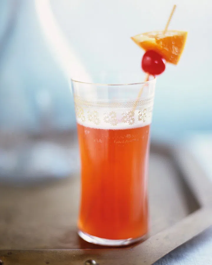 Singapore Sling made with gin, pineapple juice & cherry brandy