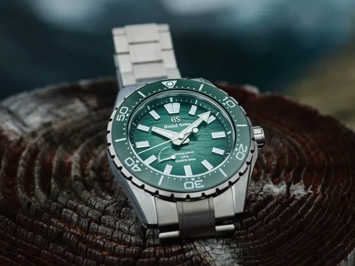 The Grand Seiko Spring Drive U.F.A. Ushio 300 Diver SLGB025 with a 40.8mm High-Intensity Titanium case, green gradient Ushio-pattern dial inspired by shallow coastal waters, unidirectional ceramic bezel, luminous Evolution 9 indexes and hands, and integrated titanium bracelet.