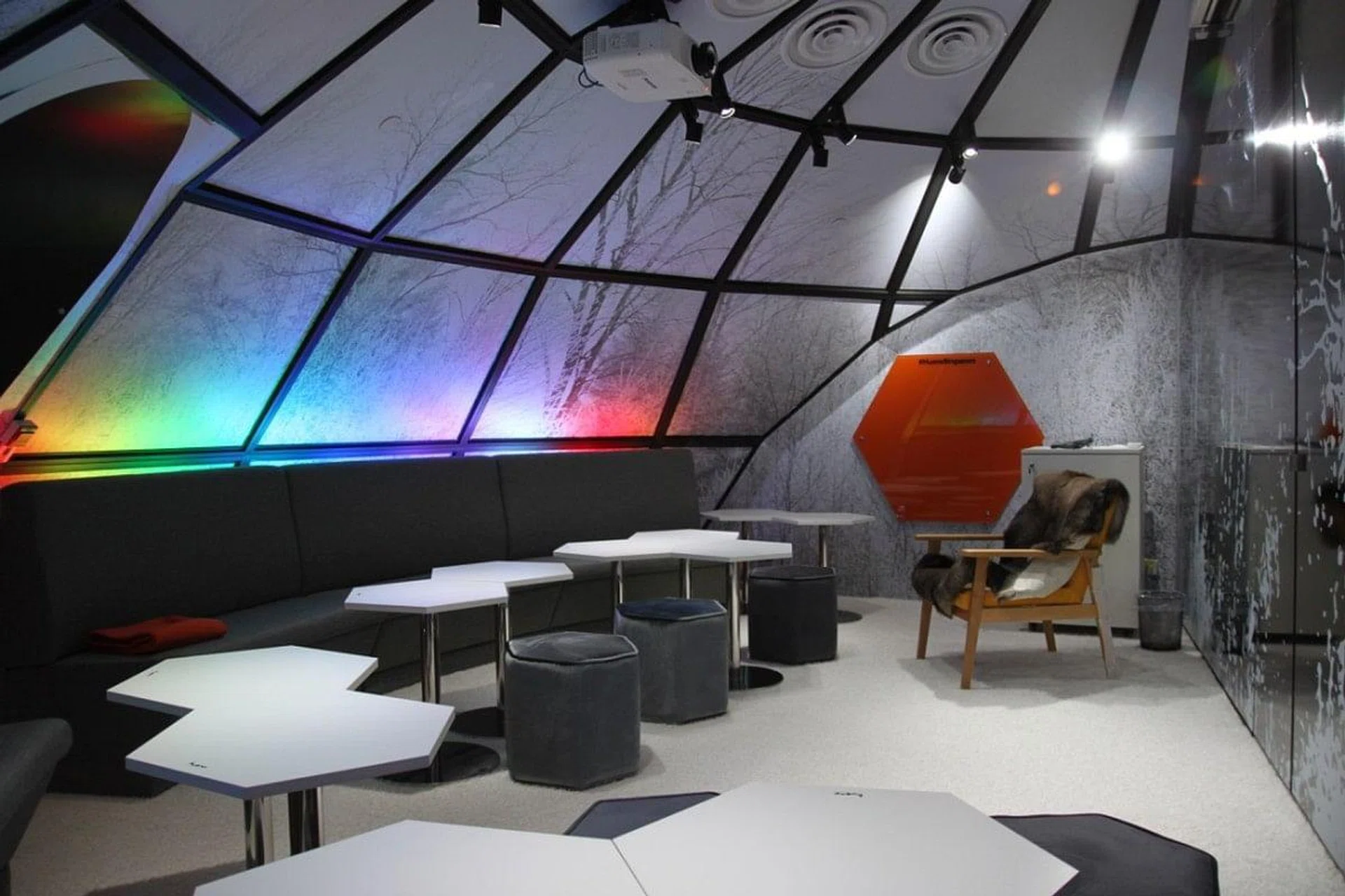 <h3>01: Igloo</h3> 
Inspired by Finland's Igloo Hotel, the sofa seating in this meeting room makes it great for conversation. Each room has adjustable light settings to create the right ambience. 