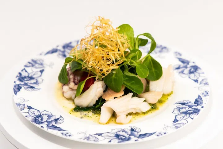 One of Ian Tan’s dishes for the World Young Chef Young Waiter competition is Madju, a creative Asian dish of squid, watercress, birds-eye, Hijau, Jicama and leek nest. (Photo: Re-Naa)