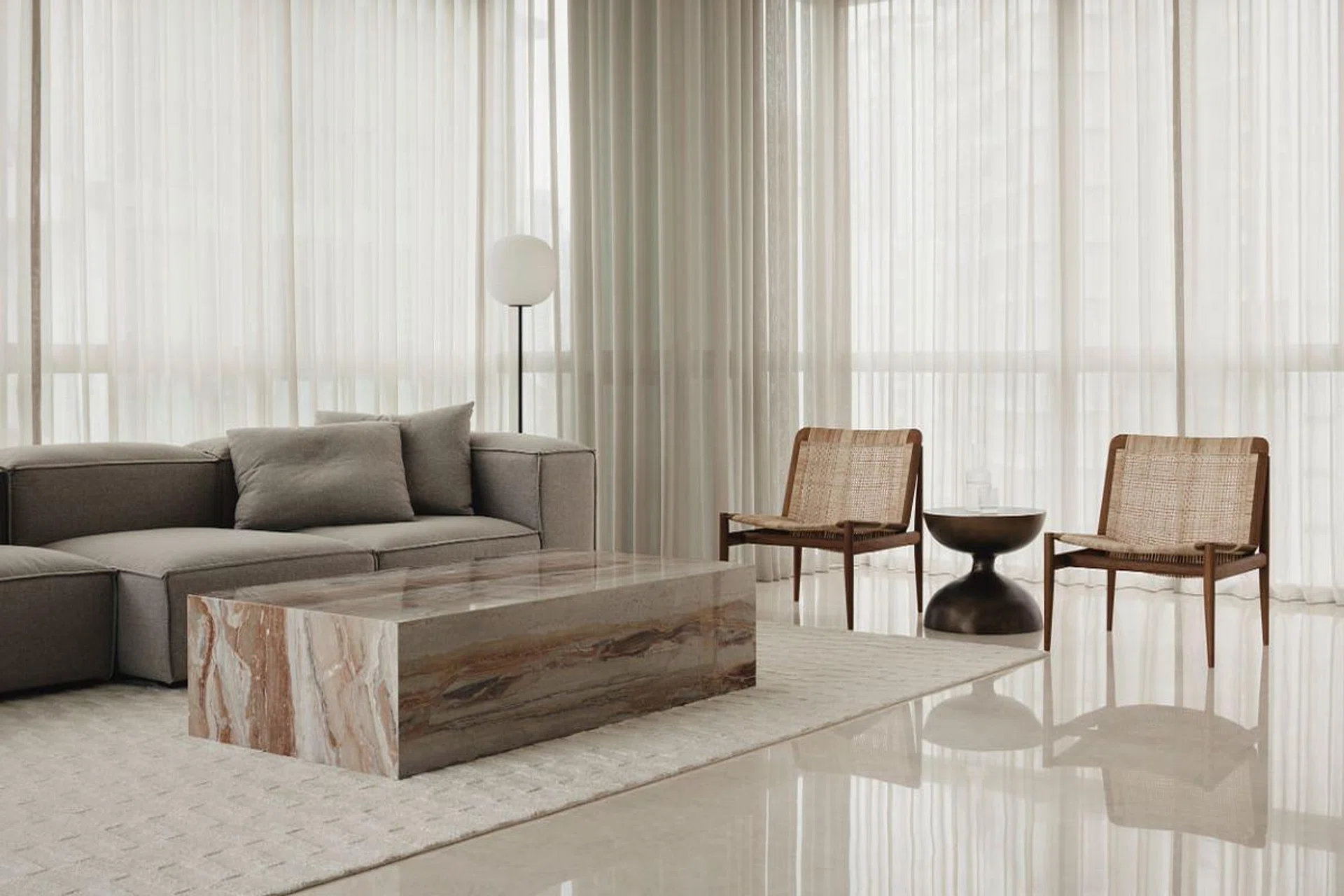 Earth and light-grey tones in the living area provide a restful feel. (Photo: Studio Periphery)