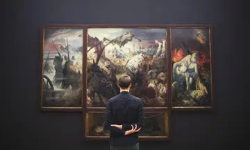 Man-admiring-painting