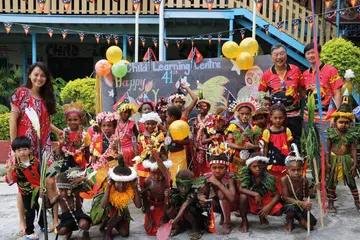 Wendi Chan and Derrick Seeto, founders and co-CEOs of Parlour Group with School Children in Papua New Guinea