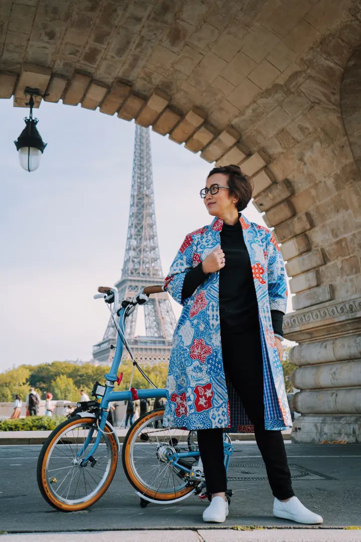 Oniatta, decked out in her designs and cycled around Paris, when invited to the city to run a pop-up shop. (Photo: Baju by Oniatta)