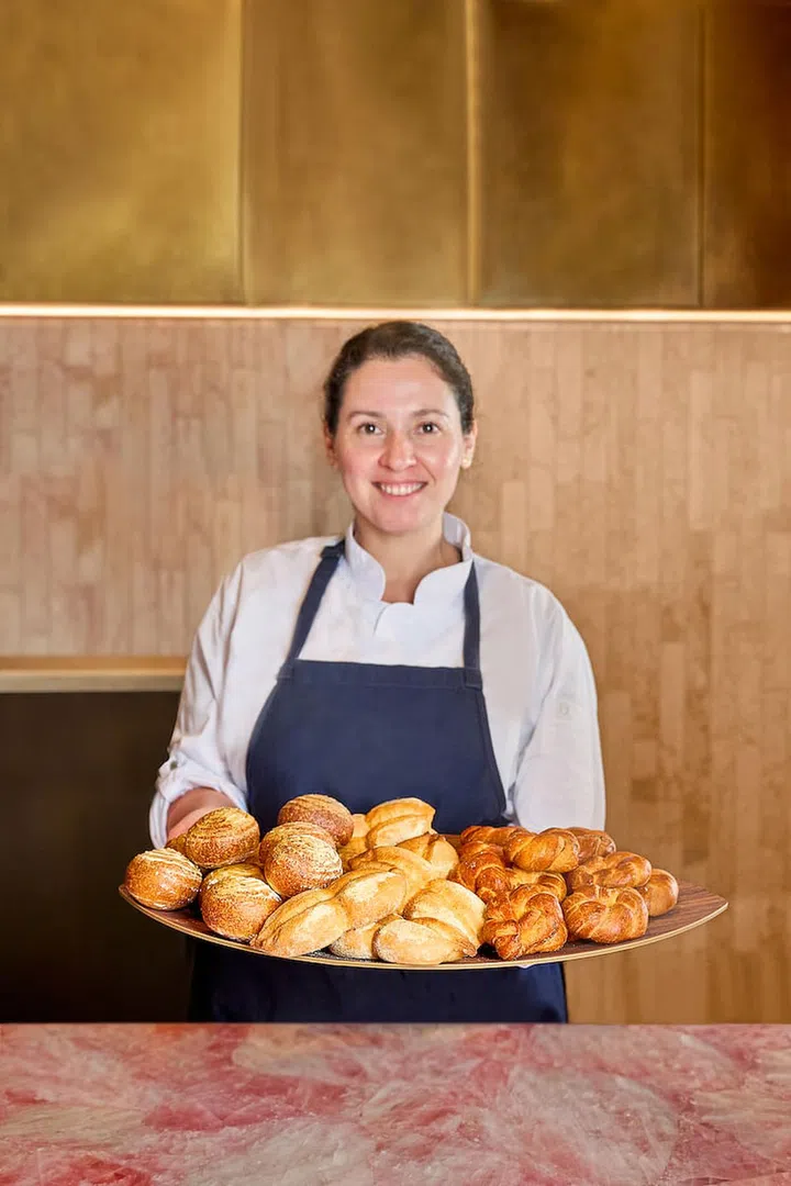 Fernanda, a pastry chef, shows off her house-made selection of bread that is served at the start of the meal. (Photo: Araya)