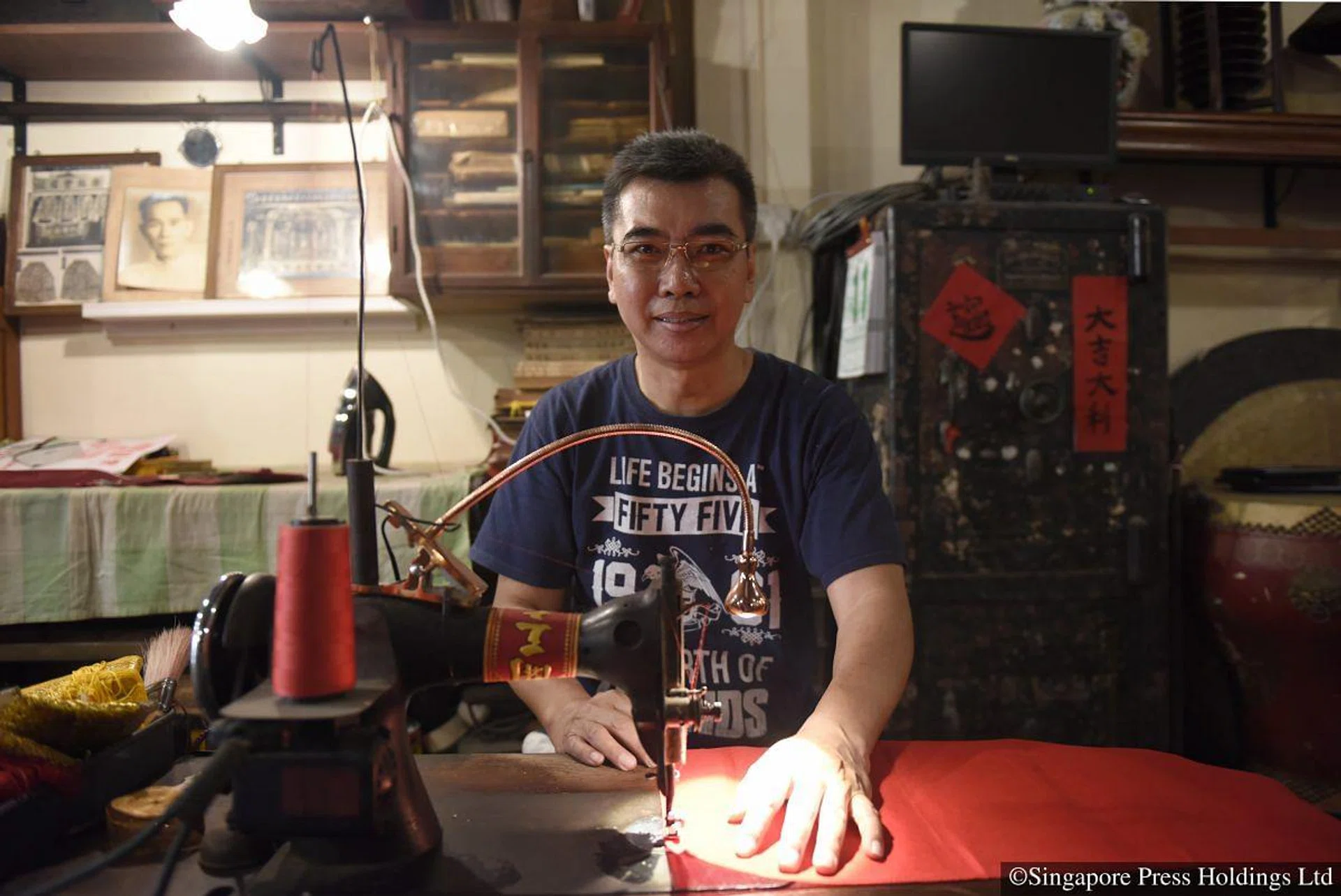 Mr Jeffrey Eng, owner of traditional Chinese craft shop Eng Tiang Huat, makes traditional red cloth banners ordered by customers to usher in Chinese New Year. He gets about 30 orders of banners during Chinese New Year. PHOTO: Nivash Joyvin