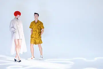 (On her) Tulle coat, polyester jacket, and leather heels, from Prada. (On him) Cotton shirt and shorts, and suede sneakers, from Tod's.