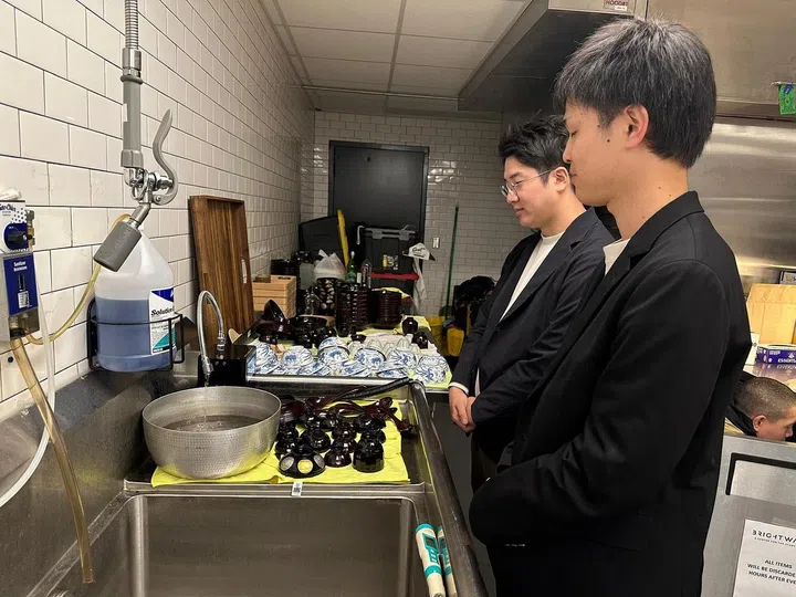 Chef Shinichiro Takagi’s water engineers at work, testing the mineral content in waters during an overseas cook-out. (Photo: Zeniya) 