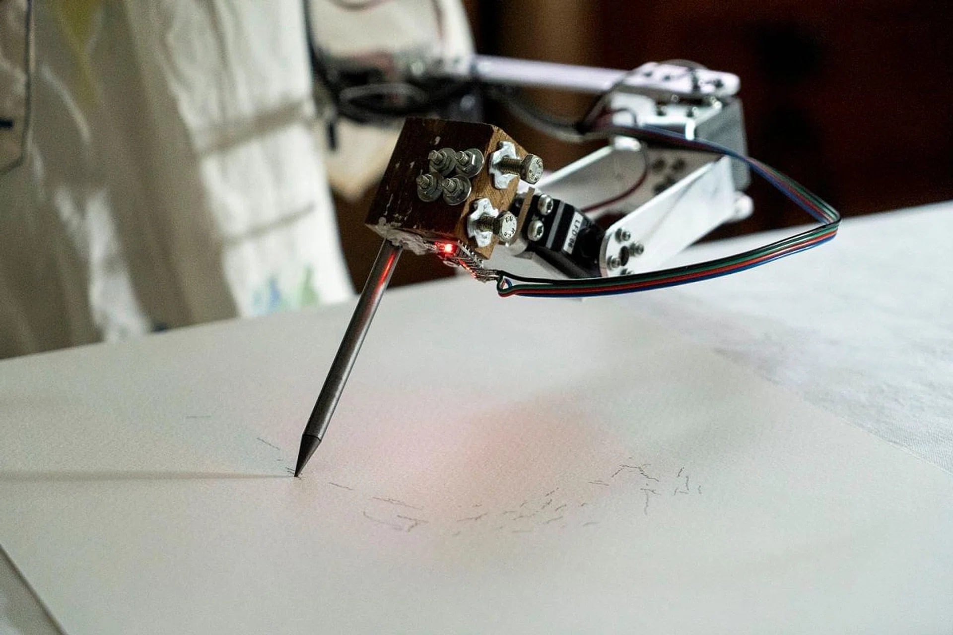 Ai-Da the AI humanoid robot artist draws a portrait of her creator Aidan Meller. (Photo by Niklas HALLE'N / AFP)