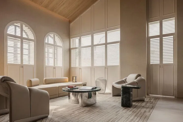 The Mondrian Shophouse Suite’s living room gets gently illuminated by sunlight coming in through the arched wooden shutters. (Photo: Mondrian Duxton Singapore)
