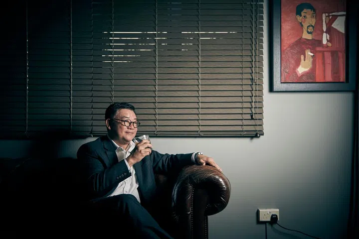 CIMB Singapore CEO Victor Lee nursing a glass of the Lagavulin 16 whisky.