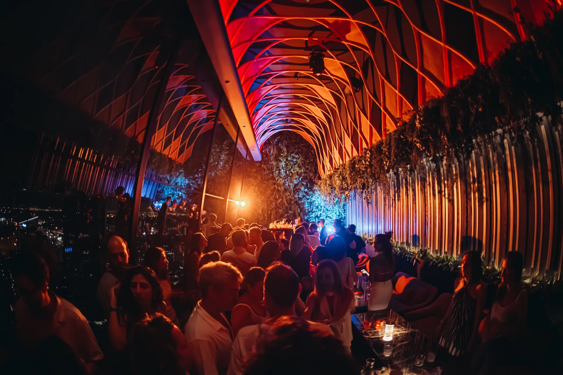 A crowd of people gather in the restaurant, SUSHISAMBA’s, lounge. 