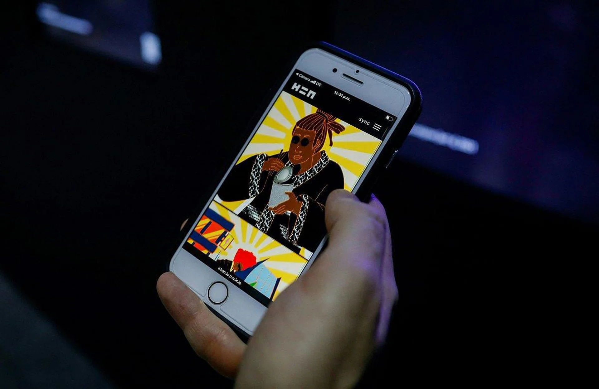 A man review NFTs artworks on his phone during Art Basel 2021 at Miami Beach Convention Center in Miami Beach, Florida, on December 2, 2021. (Photo by Eva Marie UZCATEGUI / AFP)