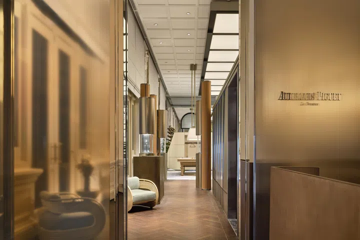 Entrance to Audemars Piguet House Singapore, with a sleek contemporary design contrasting with the colonial grandeur of its location inside Raffles Hotel