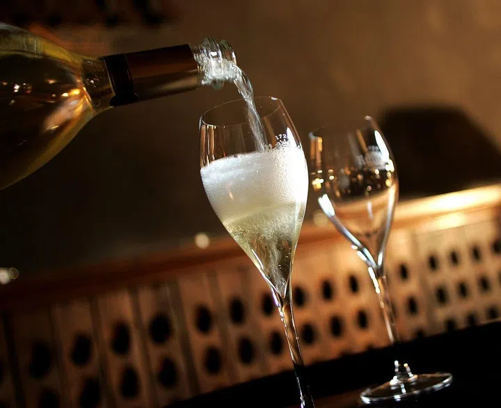 A glass of Champagne is served for a tasting, on December 11, 2008 at the producer Ruinart's cellars in Reims, northeastern France. The once sparkling shipments of France's premium export Champagne have dropped 4,9% during the first 10 months of the year, according to professionnals, but strong sales continue in emerging countries. AFP PHOTO ALAIN JULIEN