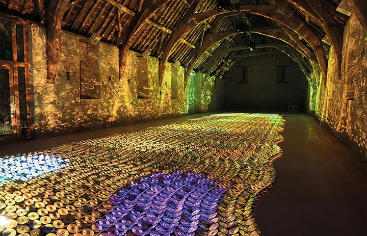 Audio-visual installation C-scales is a reflective sea of CDs and DVDs.