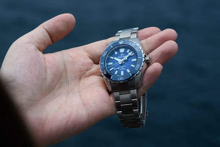 The Grand Seiko Spring Drive U.F.A. Ushio 300 Diver SLGB023 featuring a 40.8mm High-Intensity Titanium case, deep blue gradient Ushio-pattern dial inspired by ocean tides, unidirectional ceramic bezel, luminous Evolution 9 hands and indexes, and matching titanium bracelet.