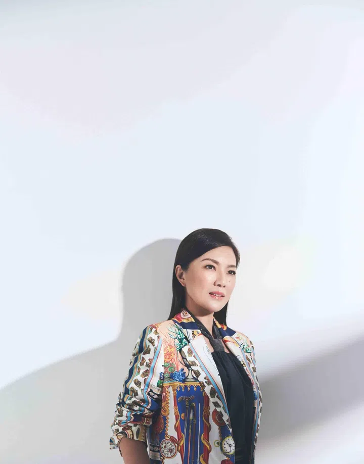 Michelle Lau is wearing an embellished silk halter blouse from Brunello Cucinelli and a silk printed jacket from Etro.