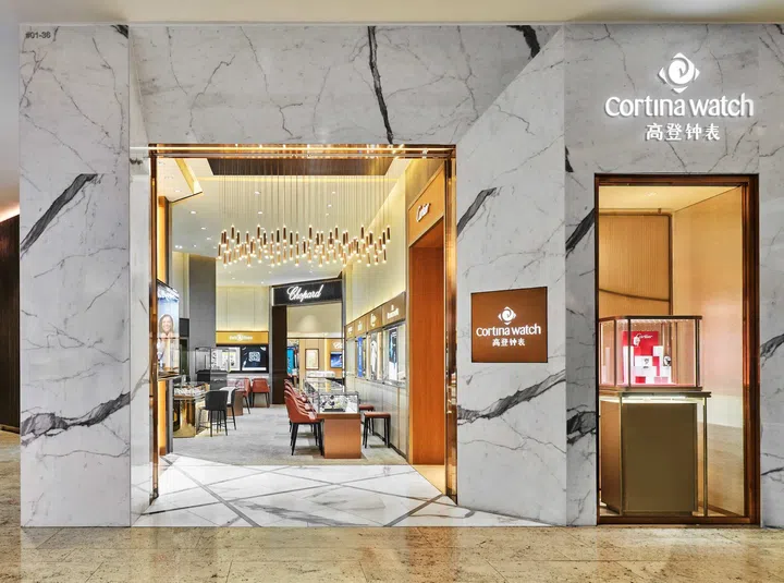Storefront view of Cortina Watch boutique at Raffles City in Singapore displaying luxury watches from leading Swiss and independent watchmakers.