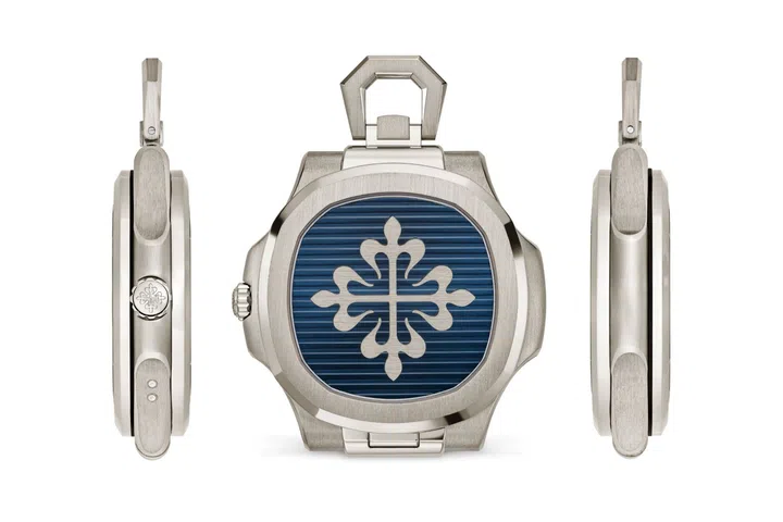 Side and caseback views of the Patek Philippe Nautilus 50th anniversary Ref. 958G-001 desk watch, showing its 13.5mm thinness and decorated hinged cover with a Calatrava cross.