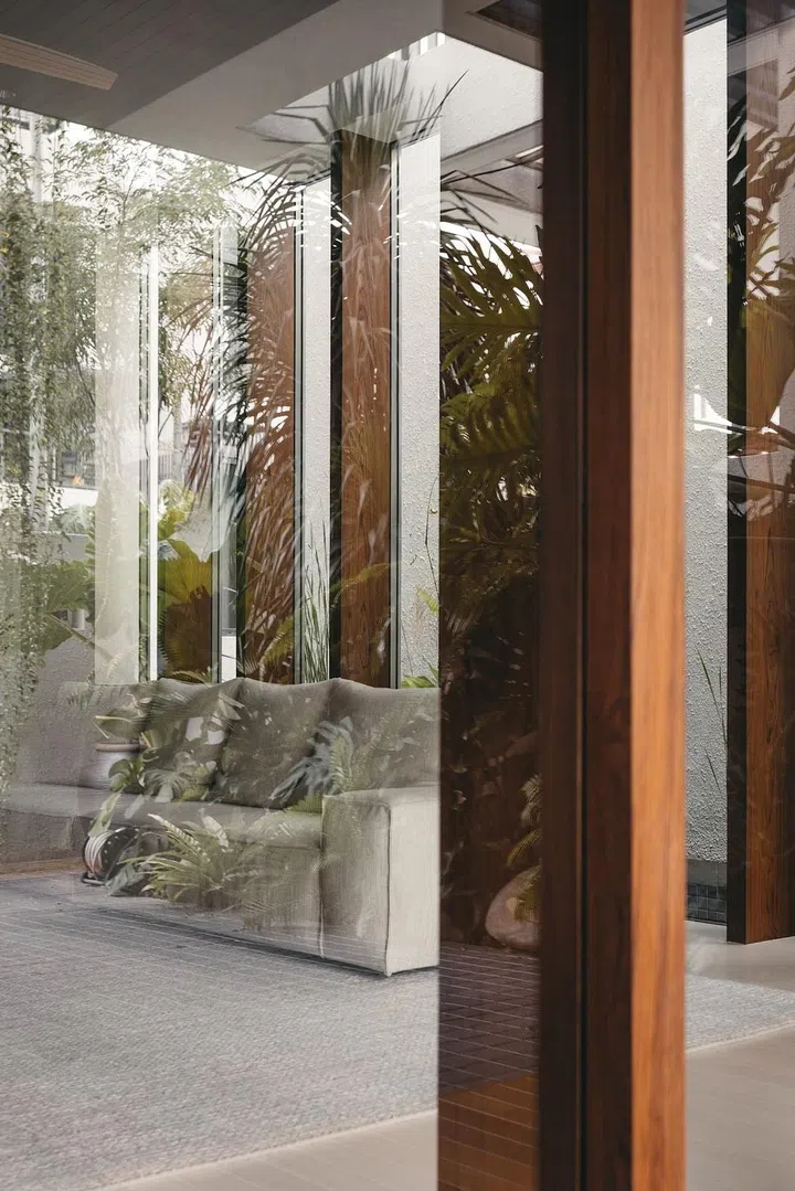 Aged teak frames provide further allusion to the resort typology. (Photo: Studio Periphery)