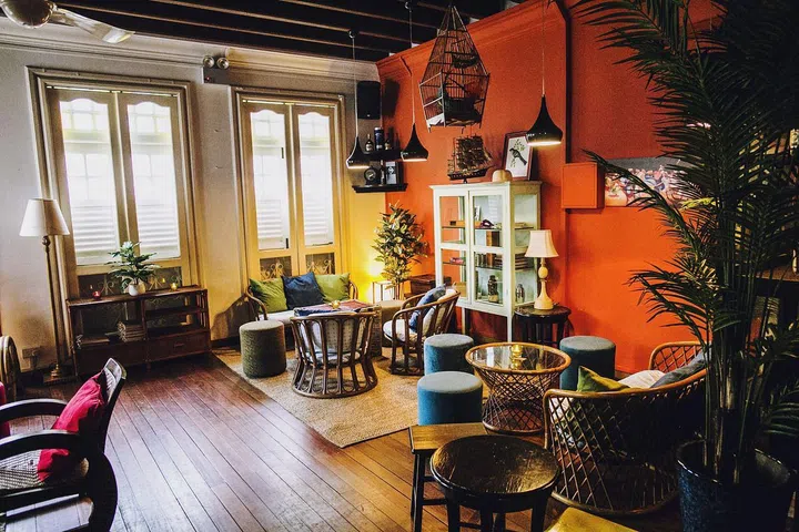 Rattan furniture and warm colours lend the second-storey bar a homely feel.