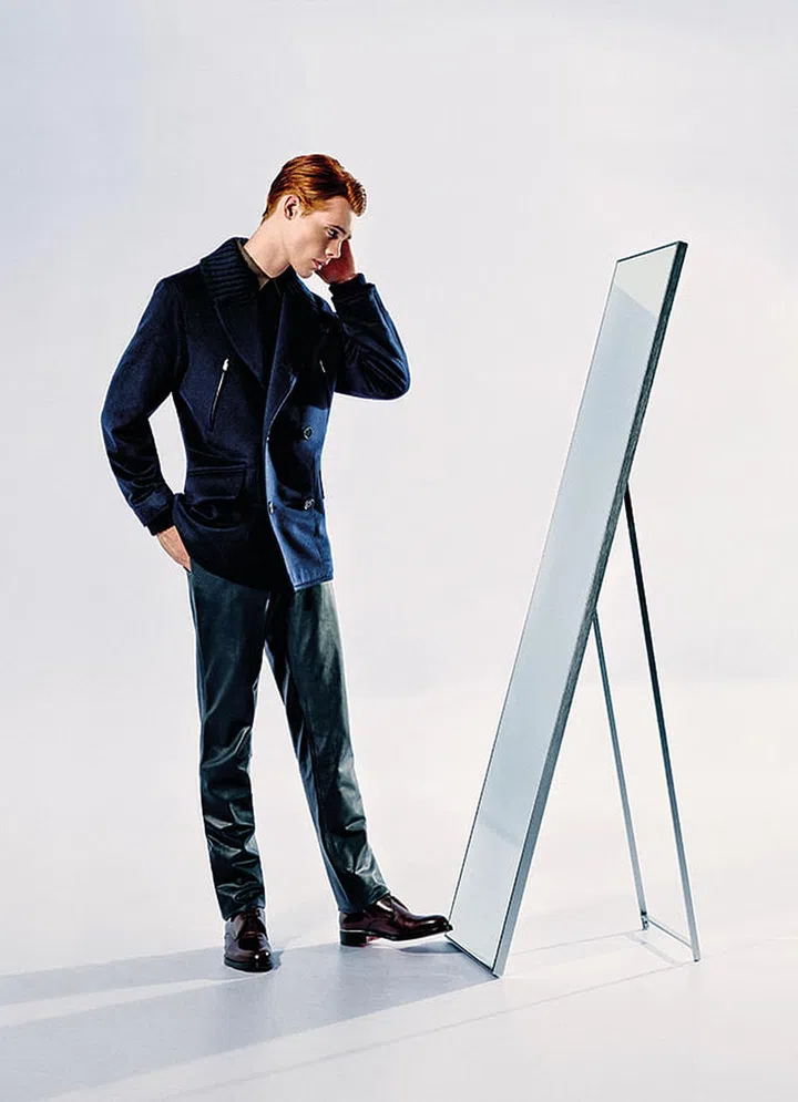 Leather pants can look sophisticated. Think sleek, not skintight. Black wool coat, navy cotton shirt, black leather pants and black leather shoes, from Hermes.