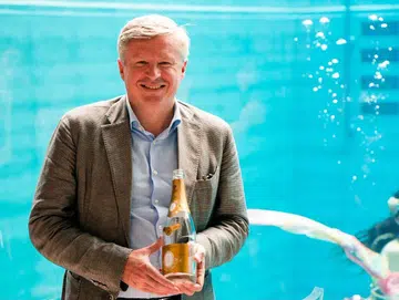 Jean-Baptiste Lécaillon, holding a bottle of 2008 Cristal