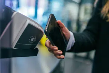 A consumer paying via mobile. Photo by Jonas Leupe on Unsplash.