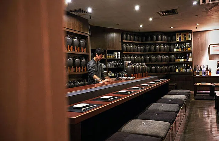 Earthenware pots line the walls at Nagomi Restaurant. They are used to store and age shochu.