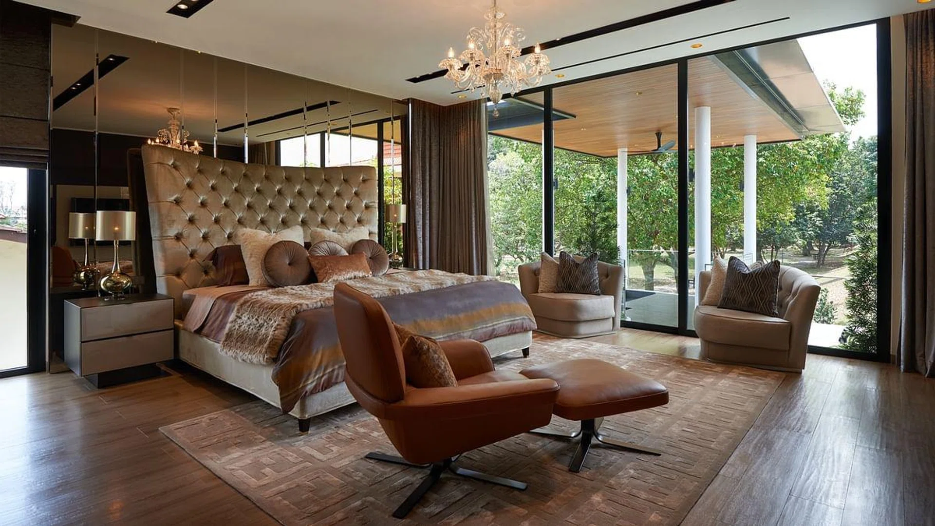 The master suite is well-furnished with a Capo D Opera Tosca bed. For lounging in the room, there's a Butterfly Armchair and an accented Minotti Blake Soft Armchair at hand.