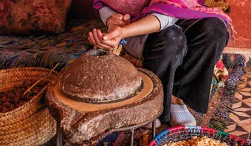 Lady sorting argan nuts for argan oil GettyImages