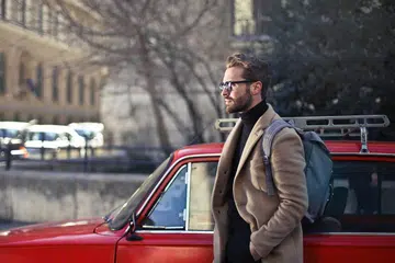 man-by-red-car-by-bruce-mars-unsplash