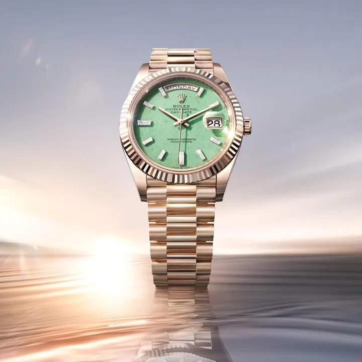 Rolex Oyster Perpetual Day-Date 40 in Jubilee Gold with light green aventurine dial, baguette-cut diamond hour markers, fluted bezel and President bracelet.