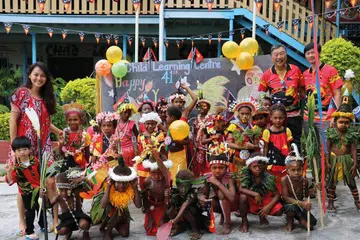Wendi Chan and Derrick Seeto, founders and co-CEOs of Parlour Group with School Children in Papua New Guinea