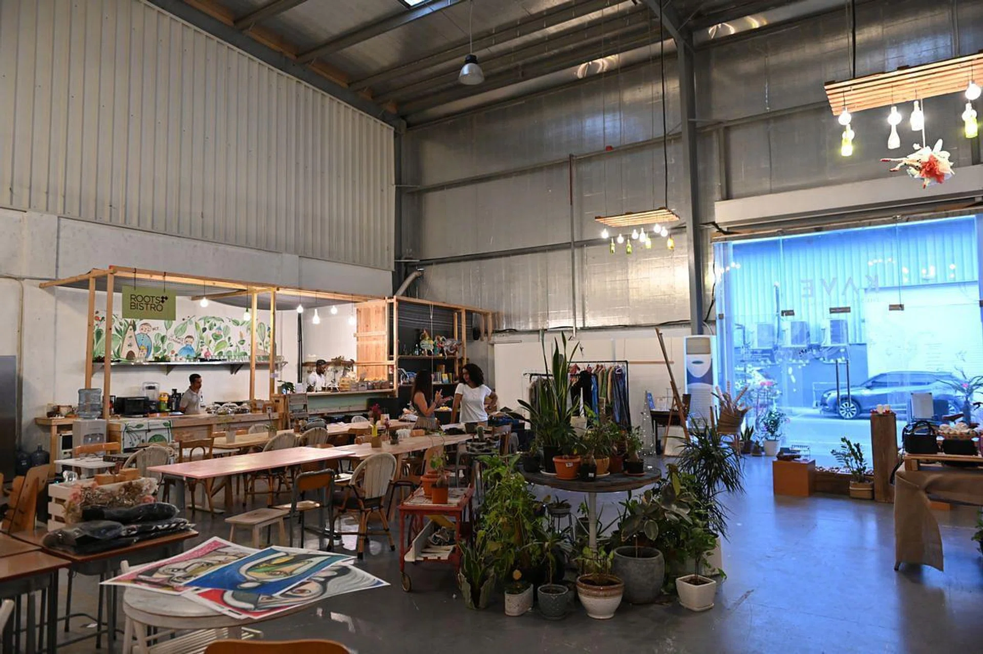 Visitors gather at The KAVE cafe at Alserkal Avenue in Dubai, on December 28, 2019. - Alserkal Avenue, is an industrial area in Dubai full of warehouses large and small that in 2008 became a hub for art galleries, start-up businesses, and quirky retail outlets. (Photo by GIUSEPPE CACACE / AFP)