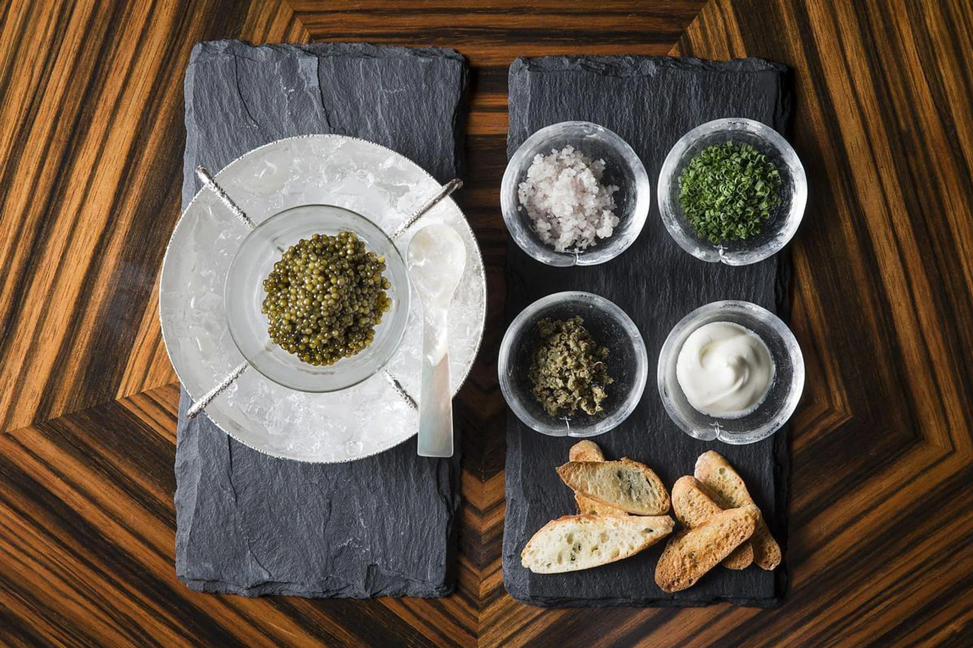 Savour luxe bar bites such as Oscietra caviar and condiments at Waku Ghin